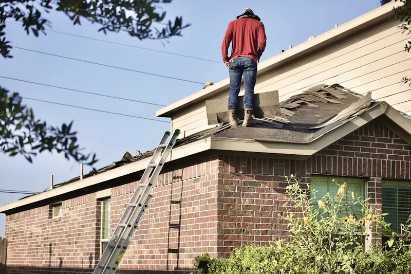 Professional roofer working on a residential roof in Northline